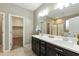 Primary bathroom featuring double sinks, a large mirror, and a walk-in shower at 30776 W Earll Dr, Buckeye, AZ 85396