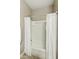 Bright bathroom with a shower-tub combination and white tile surround at 30776 W Earll Dr, Buckeye, AZ 85396