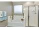 Bright bathroom with a shower and bathtub combination featuring tile surround at 30776 W Earll Dr, Buckeye, AZ 85396