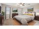 Comfortable bedroom with soft carpet, ceiling fan, and dresser with coordinating artwork at 30776 W Earll Dr, Buckeye, AZ 85396