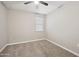 Cozy bedroom features neutral carpet, ample natural light, and a ceiling fan at 30776 W Earll Dr, Buckeye, AZ 85396