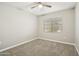 Cozy bedroom featuring neutral tones, a ceiling fan, and a bright window at 30776 W Earll Dr, Buckeye, AZ 85396