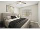 Comfortable bedroom with plush bedding, ceiling fan, and serene atmosphere for restful nights at 30776 W Earll Dr, Buckeye, AZ 85396