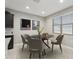 Cozy dining area with round table, seating for four, and bright natural light from the window at 30776 W Earll Dr, Buckeye, AZ 85396