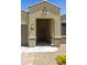 Covered front porch with decorative door and address plaque at 30776 W Earll Dr, Buckeye, AZ 85396