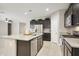 Modern kitchen featuring granite countertops, stainless steel appliances, and dark wood cabinetry at 30776 W Earll Dr, Buckeye, AZ 85396