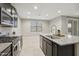 Modern kitchen with granite countertops, stainless steel appliances, and natural light at 30776 W Earll Dr, Buckeye, AZ 85396