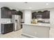 Well-appointed kitchen with stainless steel appliances, granite countertops, and ample cabinet space at 30776 W Earll Dr, Buckeye, AZ 85396