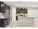 Stylish kitchen with stainless steel refrigerator, granite island, and recessed lighting at 30776 W Earll Dr, Buckeye, AZ 85396