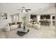 Bright living room featuring modern furnishings, stylish decor, and an open layout connecting to the kitchen at 30776 W Earll Dr, Buckeye, AZ 85396