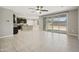 Open-concept living space with tile floors, ceiling fan, and access to the backyard at 30776 W Earll Dr, Buckeye, AZ 85396