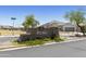 Community entrance sign with stone accents, landscaping, and clear street signage at 30776 W Earll Dr, Buckeye, AZ 85396