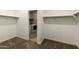 Spacious walk-in closet with hanging storage and a view of the laundry room at 30776 W Earll Dr, Buckeye, AZ 85396