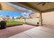 The private backyard features a covered patio, pavers, seating, and low maintenance landscaping at 3819 N Springfield St, Buckeye, AZ 85396