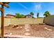 Beautiful backyard with a gravel area, a bird bath, landscaping, and a brick perimeter at 3819 N Springfield St, Buckeye, AZ 85396
