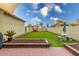 The private backyard features a covered patio, pavers, seating, and low maintenance landscaping at 3819 N Springfield St, Buckeye, AZ 85396