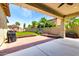Covered backyard patio features a brick-paved area, a barbecue grill, and an artificial grass lawn at 3819 N Springfield St, Buckeye, AZ 85396
