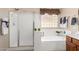 Bright bathroom featuring a large tub, a glass block window, and a separate shower, a perfect layout for relaxation at 3819 N Springfield St, Buckeye, AZ 85396