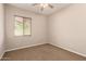 Cozy bedroom featuring carpeted floors and a window with wood blinds for natural light at 3819 N Springfield St, Buckeye, AZ 85396