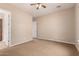 Spacious bedroom featuring neutral walls, ceiling fan, and carpet flooring providing a blank canvas for personalization at 3819 N Springfield St, Buckeye, AZ 85396