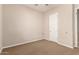 Neutral bedroom with carpet and a white door, allowing for customizable decor options and private space at 3819 N Springfield St, Buckeye, AZ 85396