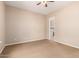 Comfortable bedroom featuring a ceiling fan, neutral carpet, and easy access to the bathroom, creating a relaxing retreat at 3819 N Springfield St, Buckeye, AZ 85396
