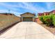 Spacious driveway with a well-maintained garage and mature landscaping at 3819 N Springfield St, Buckeye, AZ 85396