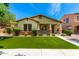 Beautifully landscaped front yard with lush greenery and a charming facade at 3819 N Springfield St, Buckeye, AZ 85396
