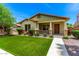 Inviting home exterior with a manicured lawn and cozy front porch at 3819 N Springfield St, Buckeye, AZ 85396