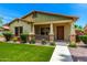 Inviting home exterior featuring a covered front porch, landscaped yard, and warm curb appeal at 3819 N Springfield St, Buckeye, AZ 85396