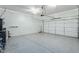 Clean garage with epoxy floor and pristine garage door provides additional storage at 3819 N Springfield St, Buckeye, AZ 85396