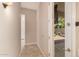 Hallway with a view to a brick-paved backyard featuring artificial grass, seating, and palm trees at 3819 N Springfield St, Buckeye, AZ 85396