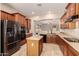 Modern kitchen featuring stainless steel appliances, an island, and a seamless flow to other living spaces at 3819 N Springfield St, Buckeye, AZ 85396