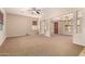 Spacious living room featuring a ceiling fan and carpet flooring, bathed in natural light at 3819 N Springfield St, Buckeye, AZ 85396