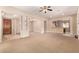 Bright and open living area with carpet flooring and seamless flow to the kitchen at 3819 N Springfield St, Buckeye, AZ 85396