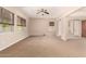 Large living room with multiple windows, ceiling fan, open floor plan, and natural light at 3819 N Springfield St, Buckeye, AZ 85396