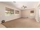 Bright, carpeted living room featuring multiple windows and neutral walls for a calming atmosphere at 3819 N Springfield St, Buckeye, AZ 85396