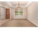 Inviting formal room with neutral walls, chandelier lighting, and large windows at 3819 N Springfield St, Buckeye, AZ 85396