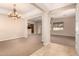Spacious living room with high ceilings, neutral carpet, and an elegant chandelier at 3819 N Springfield St, Buckeye, AZ 85396