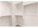 Well-organized walk-in closet with multiple tiers of shelving and rods, offering efficient storage and organization at 3819 N Springfield St, Buckeye, AZ 85396