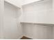 Clean and well-lit walk-in closet with ample rod and shelving space, offering plenty of room for clothes and accessories at 3819 N Springfield St, Buckeye, AZ 85396