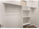 Walk-in closet with ample storage space, featuring built-in shelving, multiple rods, and neutral walls for organizing at 3819 N Springfield St, Buckeye, AZ 85396