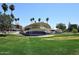 Outdoor stage with a curved canopy, surrounded by green grass and mature trees offering shade in a park at 4317 N 70Th St, Scottsdale, AZ 85251
