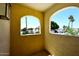 A cozy balcony showcasing arched windows and lush greenery, offering a tranquil outdoor escape at 4317 N 70Th St, Scottsdale, AZ 85251