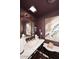 Stylish powder room with a marble countertop and dark accent wall at 4317 N 70Th St, Scottsdale, AZ 85251
