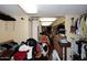 Walk-in closet with lots of hanging clothes, a dresser and storage, but also cluttered with discarded items at 4317 N 70Th St, Scottsdale, AZ 85251