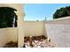 Small courtyard with neutral colored walls, decorative rocks and tree stump in an enclosed space at 4317 N 70Th St, Scottsdale, AZ 85251