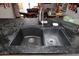 Close-up of a dual basin kitchen sink with dark countertops adding style and functionality at 4317 N 70Th St, Scottsdale, AZ 85251