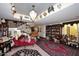 Elegant living room features a chandelier, ornate staircase, and a red chaise lounge at 4317 N 70Th St, Scottsdale, AZ 85251