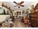 Eclectic living room featuring a ceiling fan, paintings on the walls and shelves, and a rug on the wood floor at 4317 N 70Th St, Scottsdale, AZ 85251